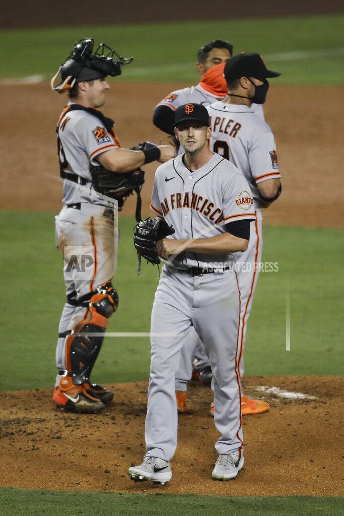 Jae C. Hong San Francisco Giants starting pitcher Drew Smyly, center, leaves the mound after he was removed by manager Gabe Kapler during the fourth inning of the team's baseball game against the Los Angeles Dodgers, Sunday, July 26, 2020, in Los Angeles. (AP Photo/Jae C. Hong)