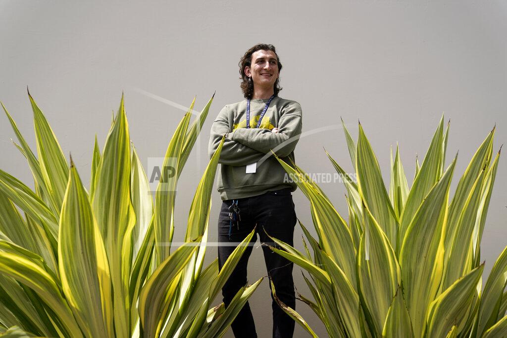 Lucius Giannini stands for a portrait Thursday, April 15, 2021, in San Diego. Giannini graduated from the University of California at San Diego at the end of last summer with a degree in political science. He had hoped to find work with the Peace Corps, or maybe teaching English overseas. But the Peace Corps was bringing all its volunteers home, and no one was hiring for overseas teaching. (AP Photo/Gregory Bull)