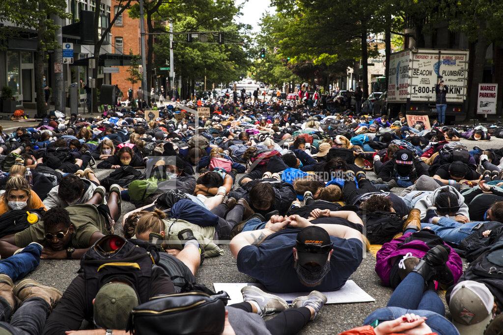 Amanda Snyder "I can't breathe," rings out as protesters lay down on 1st Avenue during the #SeattleJusticeForGeorgeFloyd march on Saturday, June 6, 2020, in Seattle, Washington. The death of George Floyd at the hands of police last month in Minneapolis has sparked nationwide protests for police reform. (Amanda Snyder/The Seattle Times via AP)