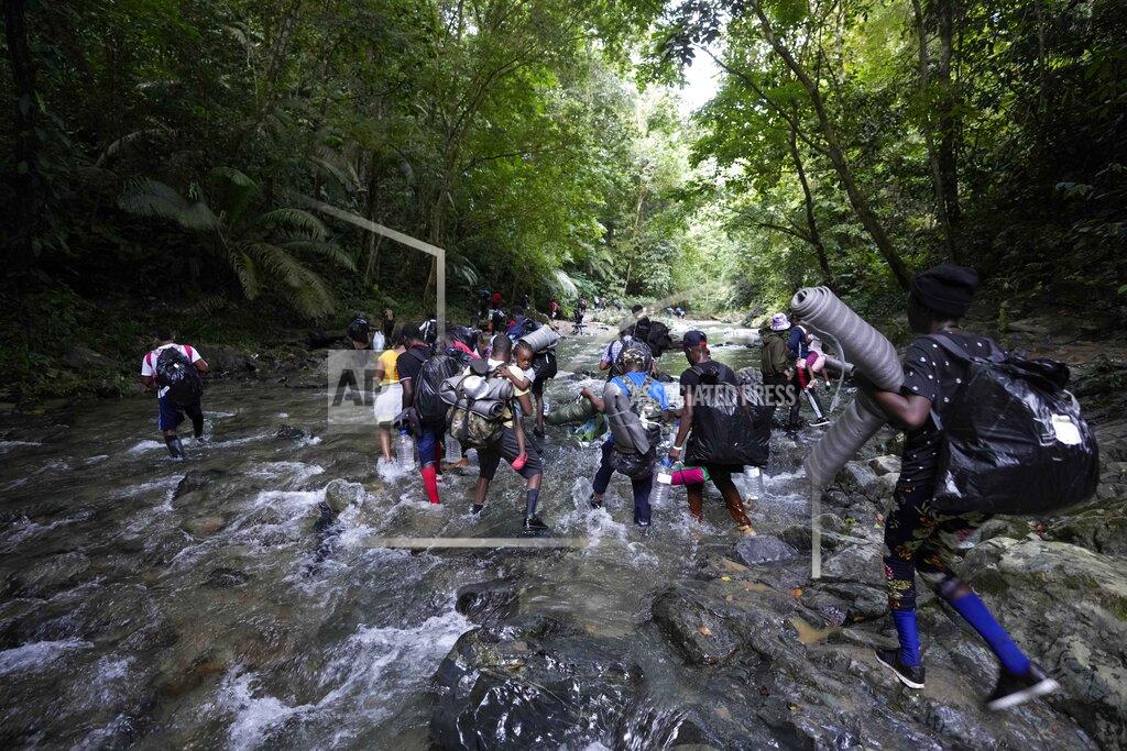 Fernando Vergara Migrants cross the Acandi River on their journey north, near Acandi, Colombia, Wednesday, Sept. 15, 2021. The migrants, mostly Haitians, are on their way to crossing the Darien Gap from Colombia into Panama dreaming of reaching the U.S. (AP Photo/Fernando Vergara)