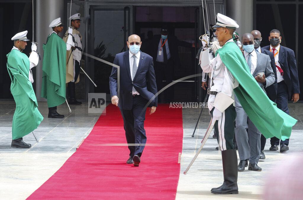 Ludovic Marin Mauritanian President Mohamed Ould Ghazouani, center, wears a face mask as he walks past a guard of honor to welcome the French president upon arrival at Nouakchott Oumtounsy International Airport Tuesday June 30, 2020, in Nouakchott, to attend a G5 Sahel summit. Leaders from the five countries of West Africa's Sahel region, Burkina Faso, Chad, Mali, Mauritania and Niger, meet with French President Emmanuel Macron and Spanish Prime Minister Pedro Sanchez in Mauritania's capital Nouakchott on Tuesday to discuss military operations against Islamic extremists in the region, as jihadist attacks mount. The five African countries, known as the G5, have formed a joint military force that is working with France, which has thousands of troops to battle the extremists in the Sahel, the region south of the Sahara Desert. (Ludovic Marin, Pool via AP)