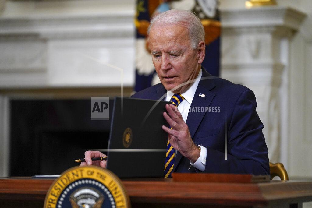 President Joe Biden closes the folder after signing an executive order relating to U.S. supply chains, in the State Dining Room of the White House, Wednesday, Feb. 24, 2021, in Washington. (AP Photo/Evan Vucci)