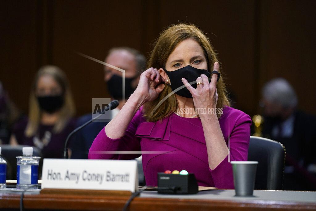 Patrick Semansky Supreme Court nominee Amy Coney Barrett removes her mask to speak during a confirmation hearing before the Senate Judiciary Committee, Monday, Oct. 12, 2020, on Capitol Hill in Washington. (AP Photo/Patrick Semansky, Pool)