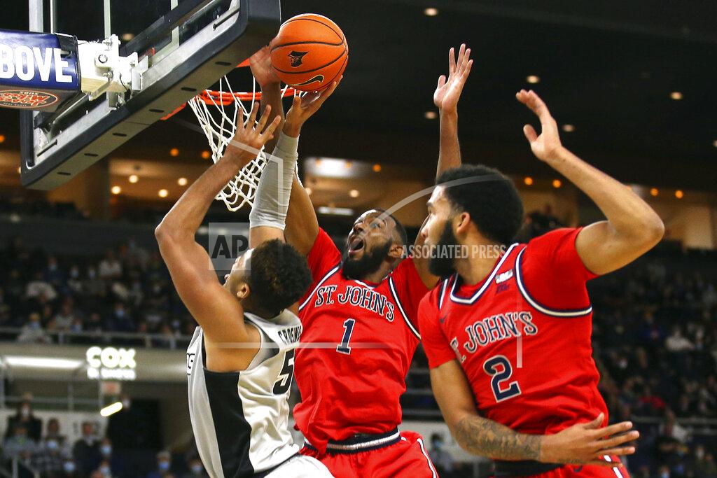 Stew Milne St. John's Aaron Wheeler (1) blocks a shot by Providence's Ed Croswell (5) as Julian Champagnie (2) helps defend on the play during the first half of an NCAA basketball game on Saturday, Jan. 8, 2022, in Providence, R.I. (AP Photo/Stew Milne)