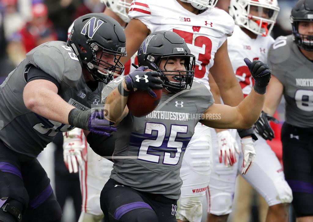 Nam Y. Huh Northwestern running back Isaiah Bowser (25) celebrates with J.B. Butler after scoring a touchdown against Wisconsin during the second half of an NCAA college football game in Evanston, Ill., Saturday, Oct. 27, 2018. Northwestern won 31-17. (AP Photo/Nam Y. Huh)