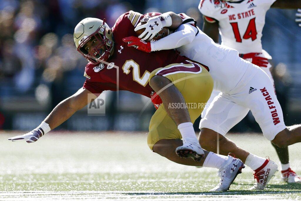 Michael Dwyer North Carolina State safety Tanner Ingle, right, tackles Boston College running back AJ Dillon (2) during the first half of an NCAA college football game in Boston, Saturday, Oct. 19, 2019. (AP Photo/Michael Dwyer)