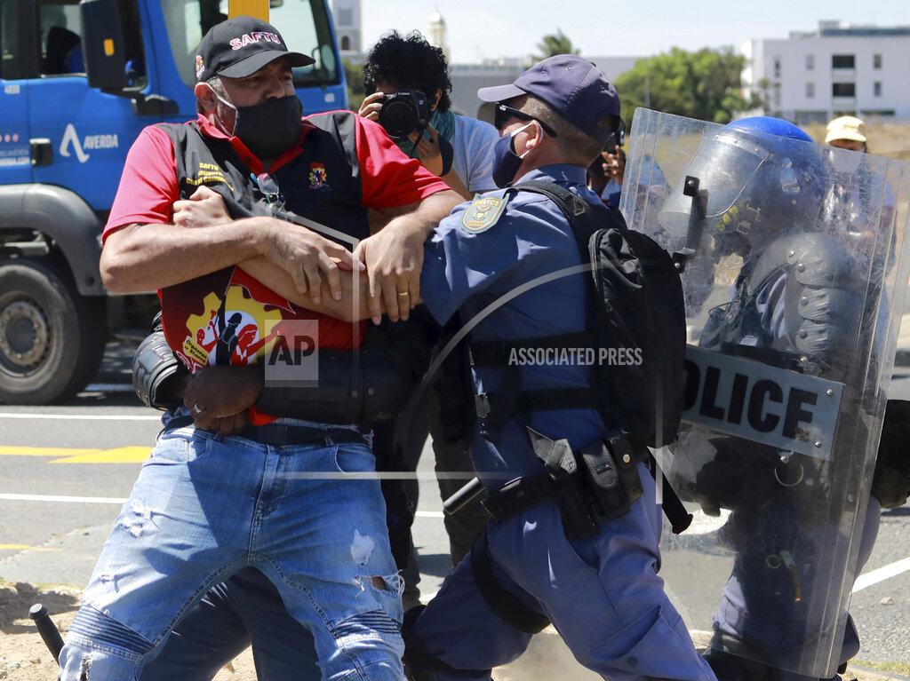 Nardus Engelbrecht Protesters clash with police at the start of a planned march to Parliament in Cape Town, South Africa, as police stop all protests before they reach parliament Wednesday, Feb. 24, 2021. Various groups planned to protest during Finance Minister Tito Mboweni's 2021 Budget Speech. (AP Photo/Nardus Engelbrecht)