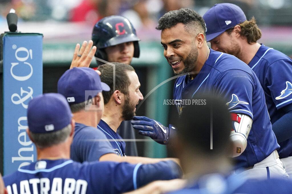 Tony Dejak Tampa Bay Rays' Nelson Cruz is congratulated by teammates after hitting a solo home run during the third inning of the teams' baseball game against the Cleveland Indians, Friday, July 23, 2021, in Cleveland. (AP Photo/Tony Dejak)
