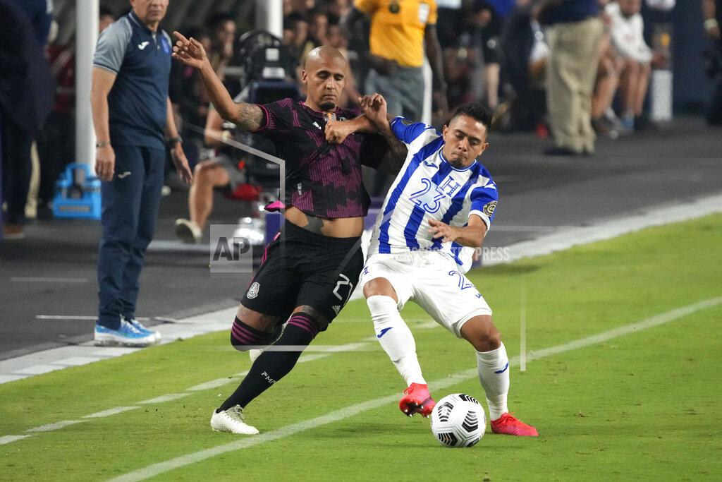 Rick Scuteri Mexico defenseman Luis Rodriguez, left, and Honduras defenseman Diego Rodriguez compete for the ball during the first half of a CONCACAF Gold Cup soccer match, Saturday, July 24, 2021, in Glendale, Ariz. (AP Photo/Rick Scuteri)
