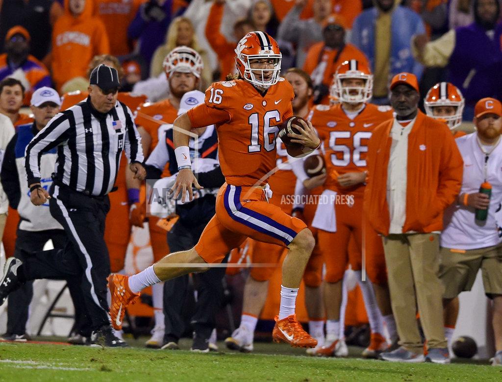 Richard Shiro Clemson quarterback Trevor Lawrence breaks away for a long rush to gain a first down during the first half of an NCAA college football game against South Carolina Saturday, Nov. 24, 2018, in Clemson, S.C. (AP Photo/Richard Shiro)