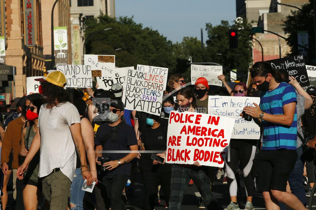 Rich Pedroncelli Demonstrators march through downtown Sacramento, Calif., Tuesday, June 2, 2020, protesting the death of George Floyd. Floyd, a black man, died after being restrained by Minneapolis police officers on May 25. (AP Photo/Rich Pedroncelli)