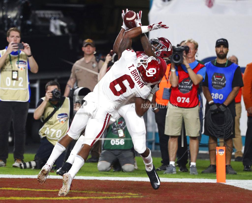 Wilfredo Lee Alabama wide receiver Henry Ruggs III (11) catches a pass in the end zone for touchdown as Oklahoma cornerback Tre Brown (6) defends, during the first half of the Orange Bowl NCAA college football game, Saturday, Dec. 29, 2018, in Miami Gardens, Fla. (AP Photo/Wilfredo Lee)