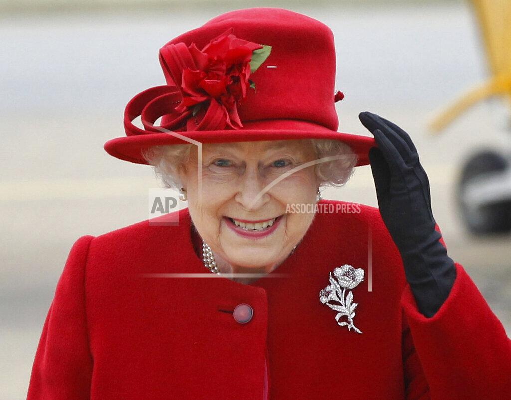 Christopher Furlong FILE - Britain's Queen Elizabeth II holds on to her hat in high winds as she arrives for a visit to RAF Valley, Anglesey, Wales on April 1, 2011. (AP Photo/Christopher Furlong, File)