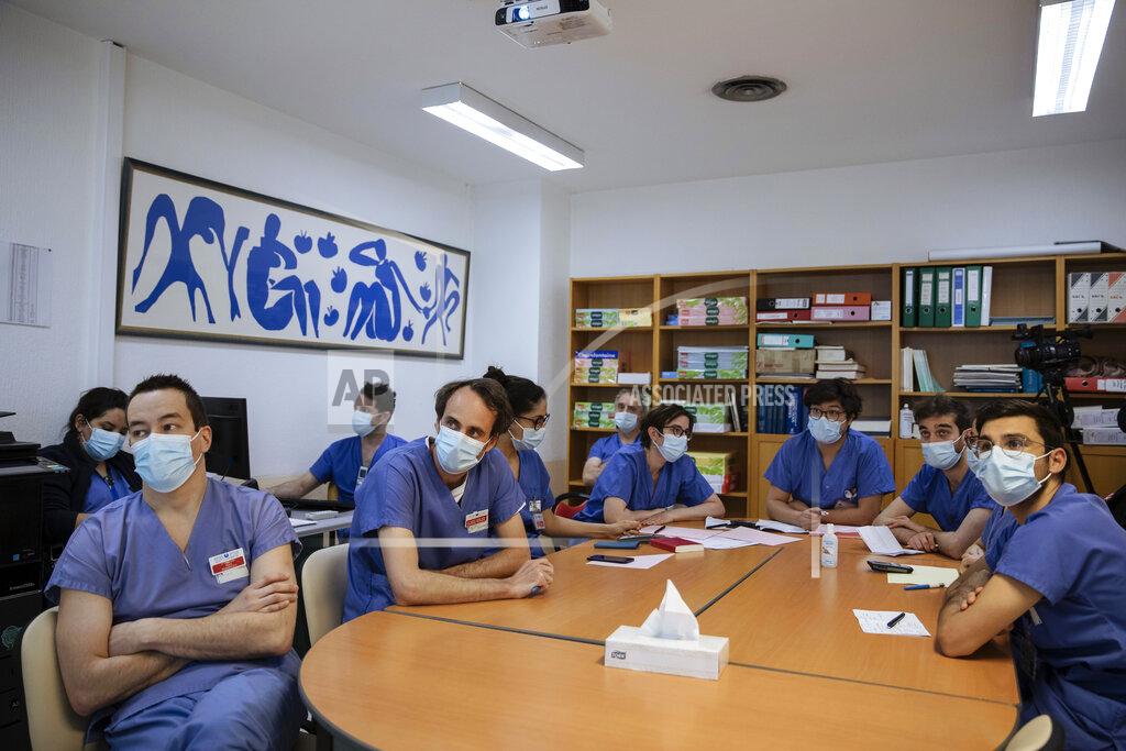 Lewis Joly Medical staff, including Dr. Alexy Tran Dinh, left, attend an afternoon meeting at Bichat Hospital, AP-HP, in Paris, Thursday, April 22, 2021. France still had nearly 6,000 critically ill patients in ICUs this week as the government embarked on the perilous process of gingerly easing the country out of its latest lockdown, too prematurely for those on pandemic frontlines in hospitals. President Emmanuel Macron's decision to reopen elementary schools on Monday and allow people to move about more freely again in May, even though ICU numbers have remained stubbornly higher than at any point since the pandemic's catastrophic first wave, marks another shift in multiple European capitals away from prioritizing hospitals. (AP Photo/Lewis Joly)