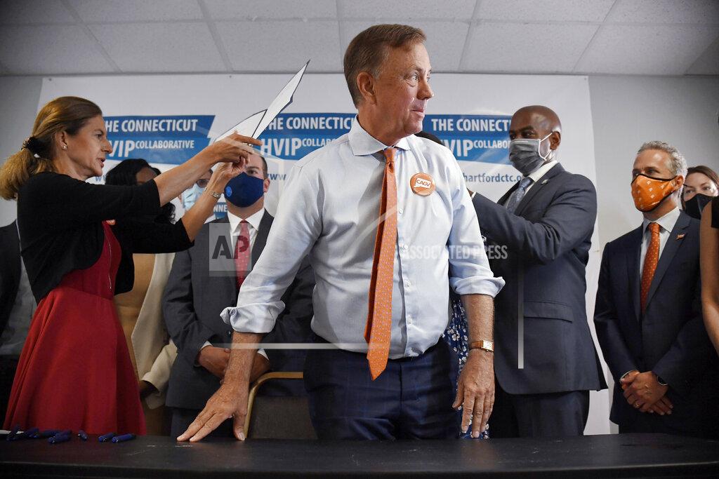 Jessica Hill Connecticut Gov. Ned Lamont stands up after signing a ceremonial bill on gun safety at Hartford Communities That Care, Tuesday, July 27, 2021 in Hartford, Conn. (AP Photo/Jessica Hill)