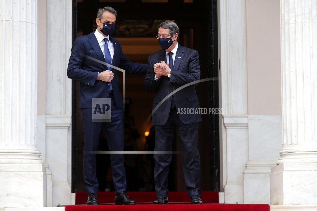 Petros Giannakouris Greece's Prime Minister Kyriakos Mitsotakis, left, welcomes Cypriot President Nicos Anastasiades at Maximos Mansion in Athens, Wednesday, March 24, 2021. The military parade on March 25, marking 200-years since the war that resulted in Greece's independence from the Ottoman Empire and rebirth as a nation, will be held without spectators due to the coronavirus, and only Greek and foreigners political officials. (AP Photo/Petros Giannakouris)