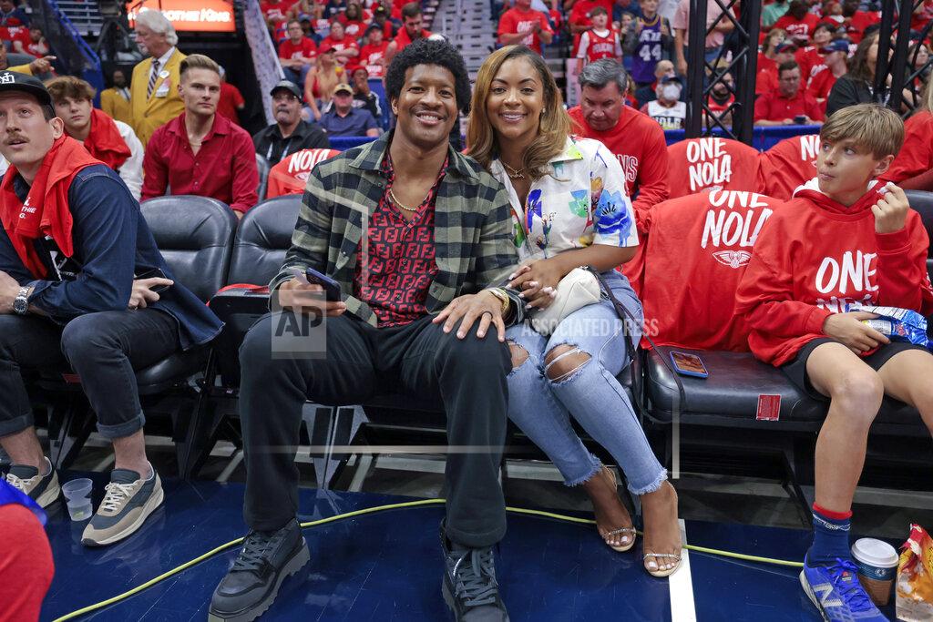 Michael Democker New Orleans Saints quarterback Jameis Winston and his wife, Breion Allen, watch Game 3 of an NBA basketball first-round playoff series between the Phoenix Suns and the New Orleans Pelicans in New Orleans, Friday, April 22, 2022. (AP Photo/Michael DeMocker)