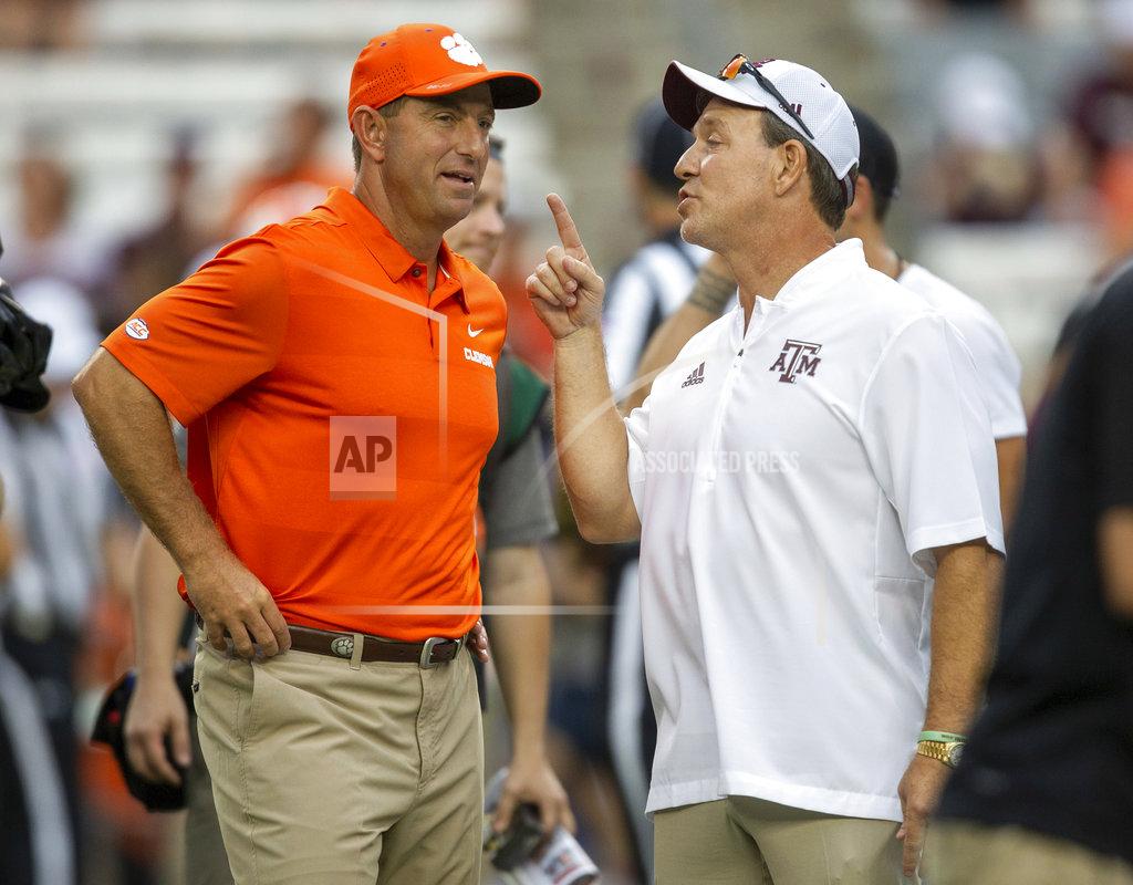 FILE - In this Sept. 8, 2018, file photo, Clemson head coach Dabo Swinney, left, and Texas A&M head coach Jimbo Fisher talk before the start of an NCAA college football game, in College Station, Texas. An example of the SEC's depth is No. 22 Texas A&M, which plays at No. 1 Alabama this week. The Aggies' only loss was to No. 3 Clemson, 28-26. (AP Photo/Sam Craft, File)