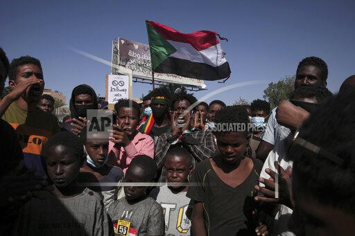 Thousands of protesters take to the streets to renew their demand for a civilian government in the Sudanese capital Khartoum, Thursday, Nov. 25, 2021. The rallies came just days after the military signed a power-sharing deal with the prime minister, after releasing him from house arrest and reinstating him as head of government. The deal came almost a month after the generals orchestrated a coup. Sudan’s key pro-democracy groups and political parties have dismissed the deal as falling short of their demands for a fully civilian rule. (AP Photo/Marwan Ali)