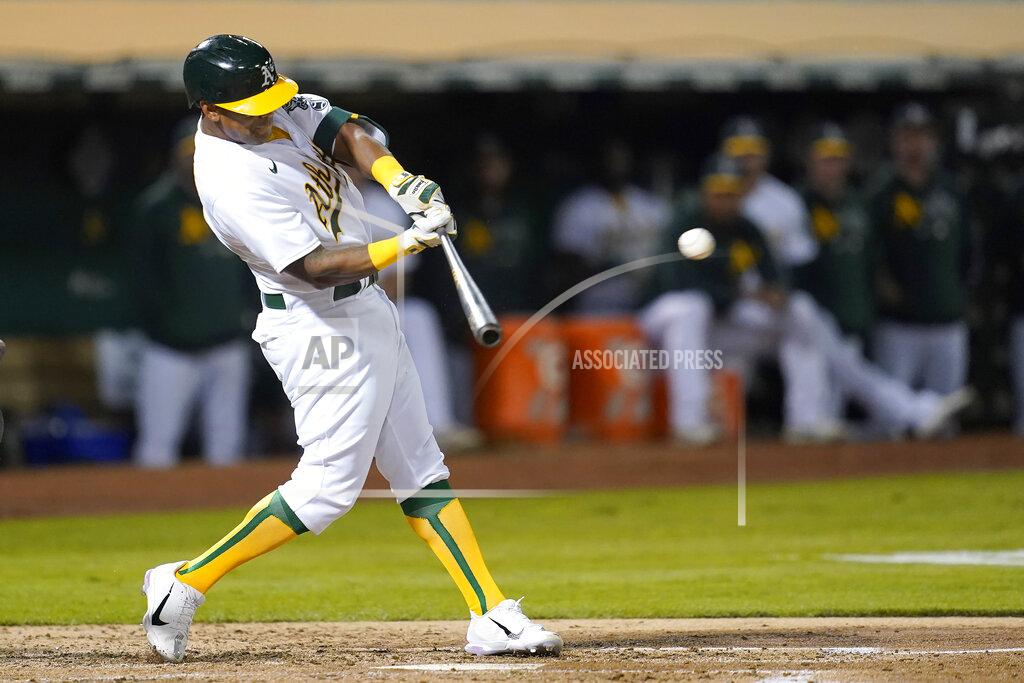 Jeff Chiu Oakland Athletics' Khris Davis hits an RBI-double against the Seattle Mariners during the third inning of a baseball game in Oakland, Calif., Monday, Sept. 20, 2021. (AP Photo/Jeff Chiu)