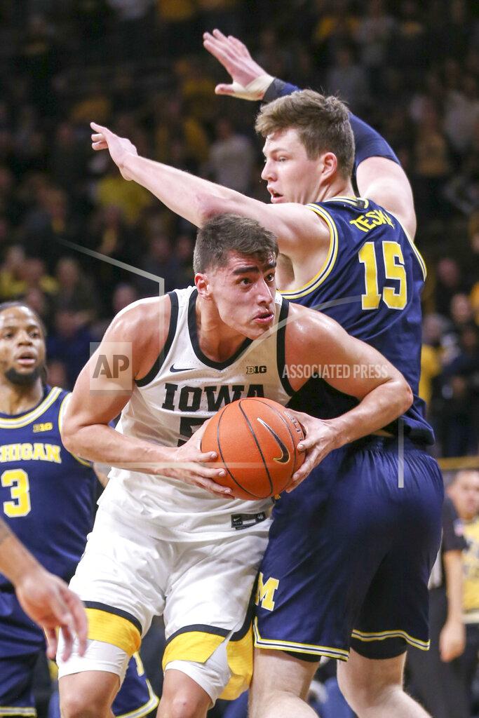 Rebecca F. Miller Iowa center Luka Garza (55) drives around Michigan center Jon Teske (15) during the first half of an NCAA college basketball game Friday, Jan. 17, 2020, in Iowa City, Iowa. (Rebecca F. Miller/The Gazette via AP)