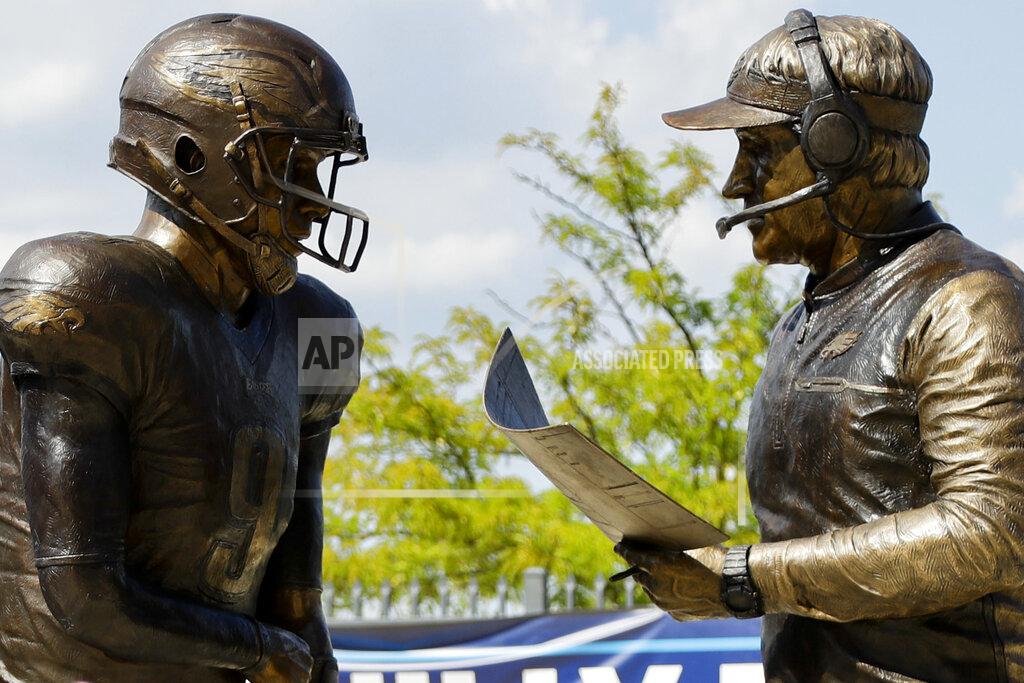 FILE - In this Sept. 5, 2018, file photo, a bronze statue depicting Philadelphia Eagles quarterback Nick Foles, left, and head coach Doug Pederson discussing the "Philly Special" trick play is seen at Lincoln Financial Field, in Philadelphia. Facing the mighty New England Patriots on the NFL's biggest stage, Philadelphia Eagles coach Doug Pederson's decision to try a trick play _ the "Philly Special" _ on a fourth down late in the first half of Super Bowl 52 will be remembered as one of the gutsiest calls in sports history. (AP Photo/Matt Slocum, FIle)