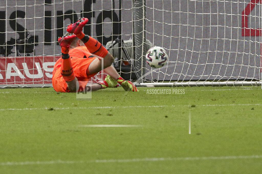 Michael Sohn Leverkusen's goalkeeper Lukas Hradecky concedes the third goal, scored by Bayern's Robert Lewandowski during the German soccer cup (DFB Pokal) final match between Bayer 04 Leverkusen and FC Bayern Munich in Berlin, Germany, Saturday, July 4, 2020. (AP Photo/Michael Sohn)