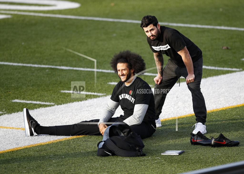 Todd Kirkland Free agent quarterback Colin Kaepernick, left, stretches before a workout for NFL football scouts and media, Saturday, Nov. 16, 2019, in Riverdale, Ga. (AP Photo/Todd Kirkland)