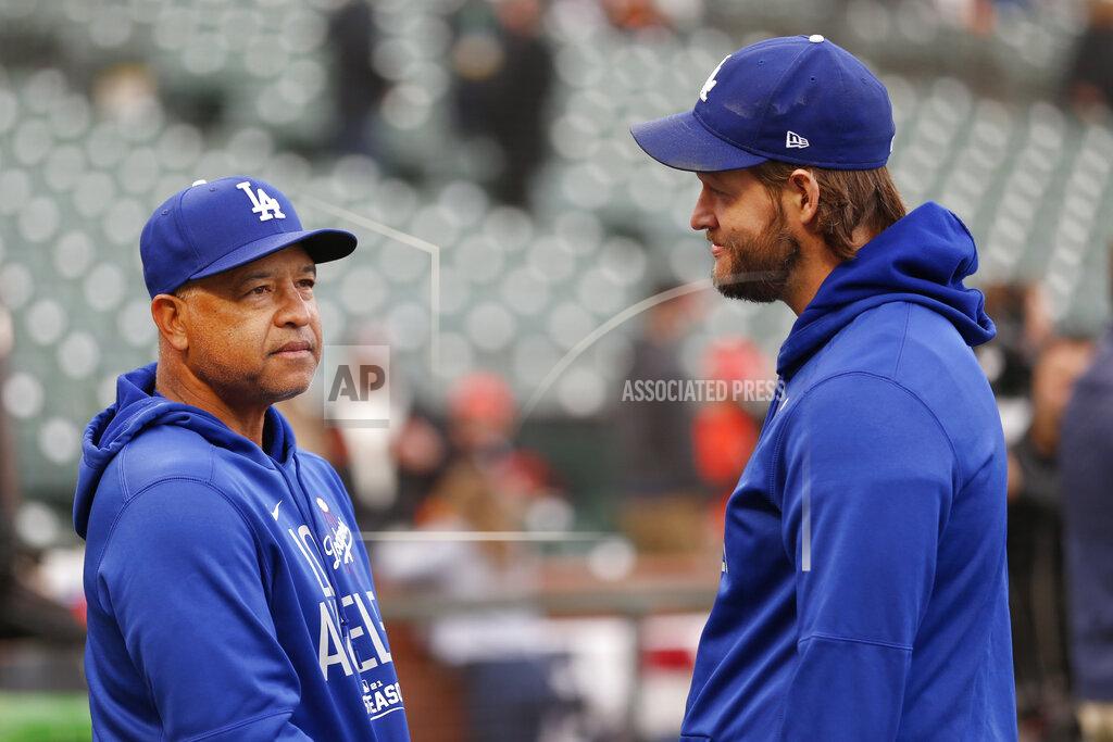 Jed Jacobsohn Los Angeles Dodgers manager Dave Roberts, left, talks with injured pitcher Clayton Kershaw before Game 1 of a baseball National League Division Series against the San Francisco Giants Friday, Oct. 8, 2021, in San Francisco. (AP Photo/Jed Jacobsohn)