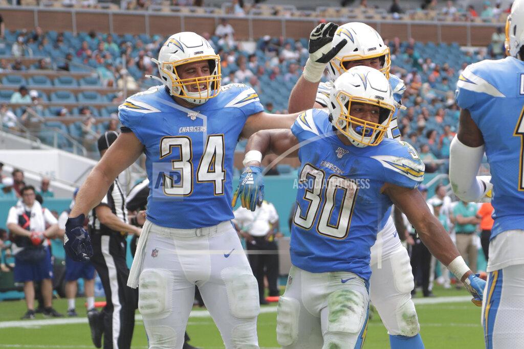 Lynne Sladky Los Angeles Chargers fullback Derek Watt (34) and offensive guard Michael Schofield (75) congratulate running back Austin Ekeler (30) after Ekeler scored a touchdown, during the second half at an NFL football game against the Miami Dolphins, Sunday, Sept. 29, 2019, in Miami Gardens, Fla. (AP Photo/Lynne Sladky)