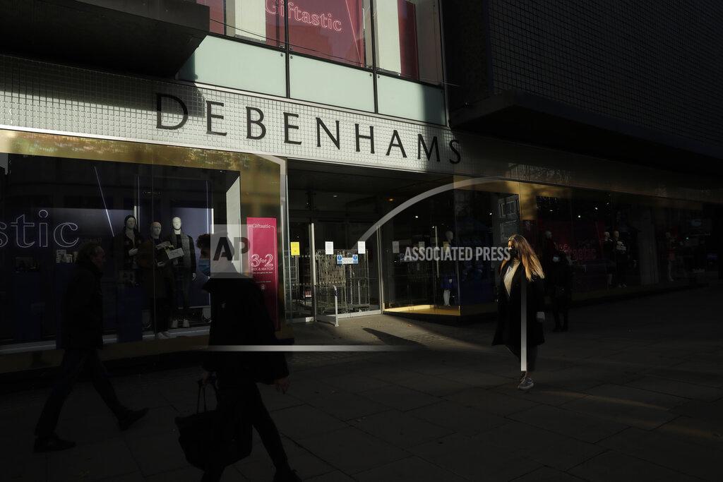 Matt Dunham People wearing face masks walk past the Debenhams flagship department store on Oxford Street, in London, Tuesday, Dec. 1, 2020. In another dark day for the British retailing industry, Debenhams said Tuesday it will start liquidating its business after a potential buyer of the company pulled out, a move that looks like it will cost 12,000 workers their jobs. (AP Photo/Matt Dunham)