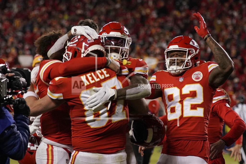 Charlie Riedel Kansas City Chiefs tight end Travis Kelce (87) celebrates with teammates after catching an 8-yard touchdown pass during overtime in an NFL divisional round playoff football game against the Buffalo Bills, Sunday, Jan. 23, 2022, in Kansas City, Mo. The Chiefs won 42-36. (AP Photo/Charlie Riedel)