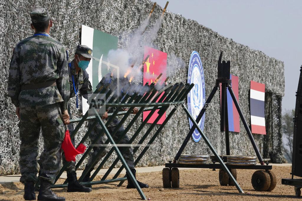 Ng Han Guan Chinese soldiers let off signal flares during the Shared Destiny 2021 drill at the Queshan Peacekeeping Operation training base in Queshan County in central China's Henan province Wednesday, Sept. 15, 2021. Peacekeeping troops from China, Thailand, Mongolia and Pakistan took part in the 10 days long exercise that field reconnaissance, armed escort, response to terrorist attacks, medical evacuation and epidemic control. (AP Photo/Ng Han Guan)