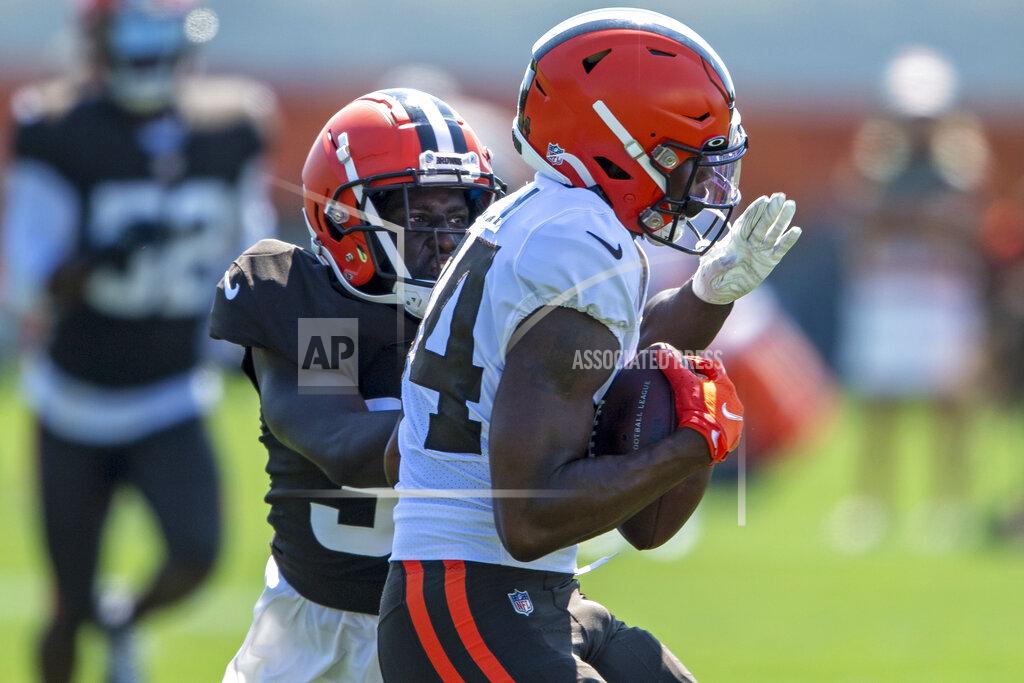 Cleveland Browns defensive back Emmanuel Rugamba, back, breaks up a pass intended for receiver Ja'Marcus Bradley during an NFL football practice in Berea, Ohio, Wednesday, Aug. 4, 2021. (AP Photo/David Dermer)