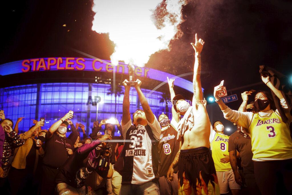 Los Angeles Lakers fans celebrate outside of Staples Center, Sunday, Oct. 11, 2020, in Los Angeles, after the Lakers defeated the Miami Heat in Game 6 of basketball's NBA Finals to win the championship. (AP Photo/Christian Monterrosa)