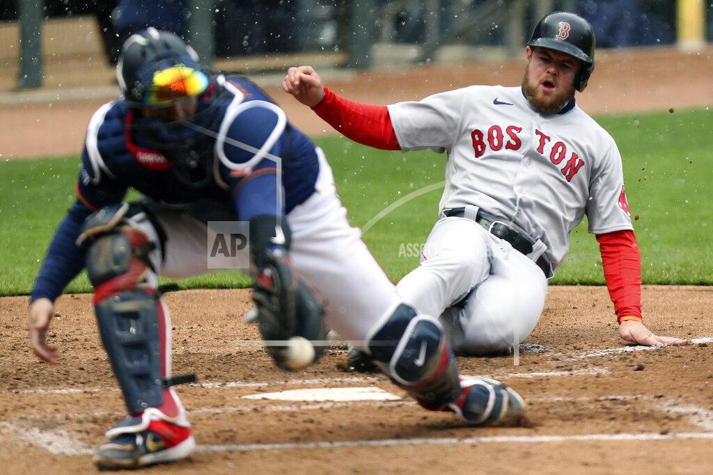 Stacy Bengs Boston Red Sox Christian Arroyo (39) slides safely into home base after Boston Red Sox Bobby Dalbec (29) hit a sharp line drive against the Minnesota Twins during the fifth inning of a baseball game, Tuesday, April 13, 2021, in Minneapolis. Boston won 4-2. (AP Photo/Stacy Bengs)