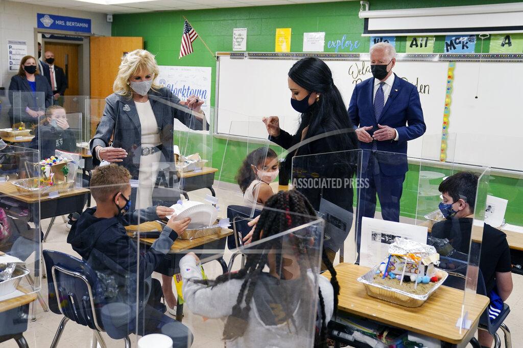Evan Vucci President Joe Biden, first lady Jill Biden and fifth-grade teacher Cindy Bertamini, watch a student demonstrate his project, during a visit to Yorktown Elementary School, Monday, May 3, 2021, in Yorktown, Va. (AP Photo/Evan Vucci)