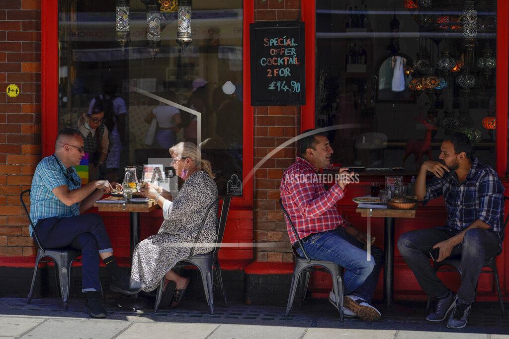 Alberto Pezzali People sit at outdoor tables at a restaurant in Soho, in London, Monday, June 14, 2021. British Prime Minister Boris Johnson is expected to confirm Monday that the next planned relaxation of coronavirus restrictions in England will be delayed as a result of the spread of the delta variant first identified in India. (AP Photo/Alberto Pezzali)