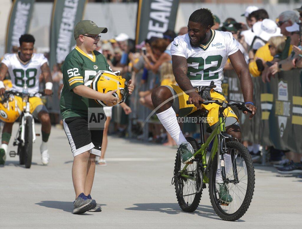 Morry Gash Green Bay Packers' Dexter Williams rides a bike to NFL football training camp Thursday, July 25, 2019, in Green Bay, Wis. (AP Photo/Morry Gash)