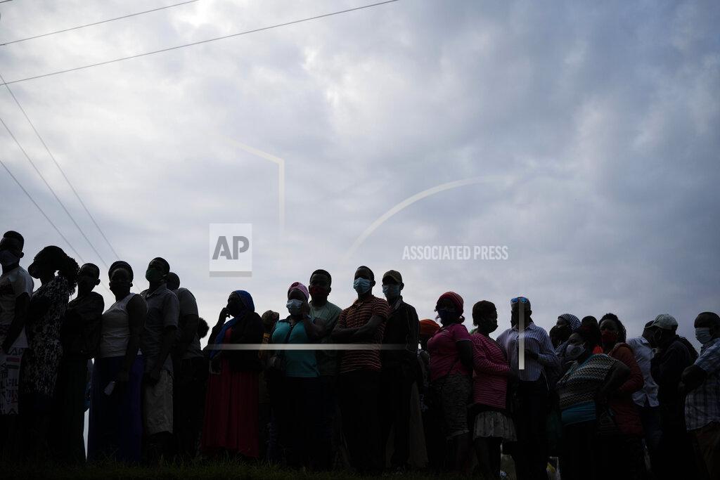 Jerome Delay Ugandans wait to vote in Kampala, Uganda, Thursday, Jan. 14, 2021. Ugandans are voting in a presidential election tainted by widespread violence that some fear could escalate as security forces try to stop supporters of leading opposition challenger BobiWine from monitoring polling stations.(AP Photo/Jerome Delay)