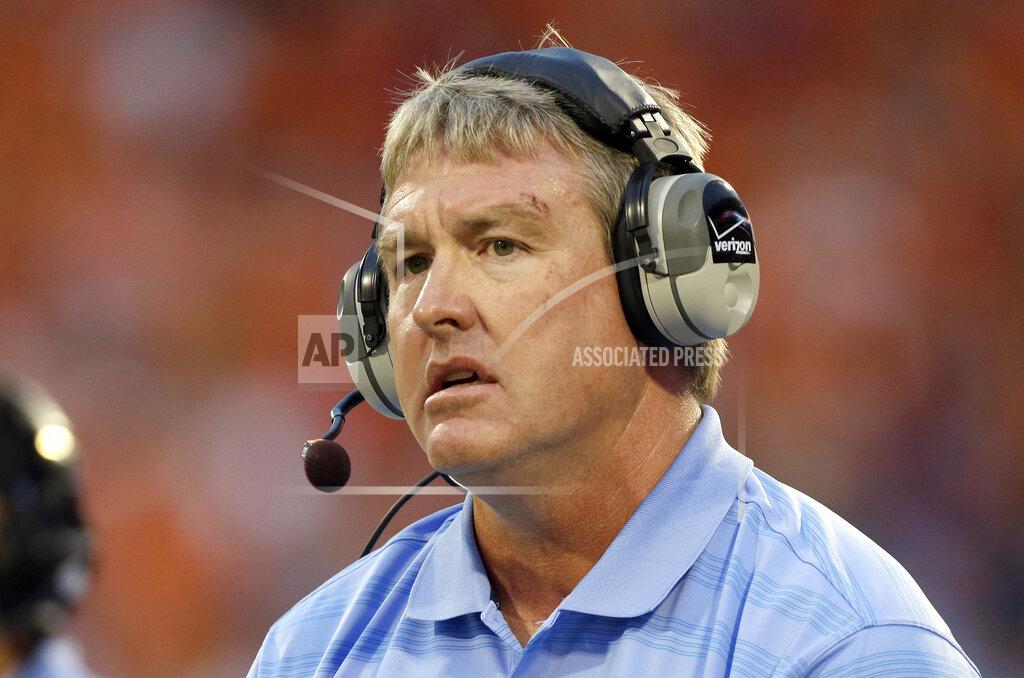 Bob Leverone FILE - In this Sept. 27, 2014, file photo, Vic Koenning, at the time the defensive coordinator at North Carolina, watches during the first half of the team's NCAA college football game against Clemson in Clemson, S.C. West Virginia has parted ways with defensive coordinator Vic Koenning a month after safety Kerry Martin alleged he made a series of insensitive remarks, including against Hispanics. (AP Photo/Bob Leverone, File)