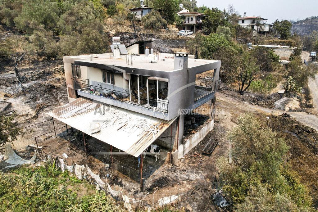 Uncredited An aerial photo shows the destruction caused by wildfires near the Mediterranean coastal town of Manavgat, Antalya, Turkey, Friday, July 30, 2021. The death toll in a string of wildfires raging in southern Turkey rose to four, officials said Friday, as fire crews continued to battle blazes that burned down homes and forced people to evacuate settlements and beach resorts. Firefighters were still tackling wildfires in 14 locations in six provinces in Turkey's Mediterranean and southern Aegean region, President Recep Tayyip Erdogan told reporters. (AP Photo)
