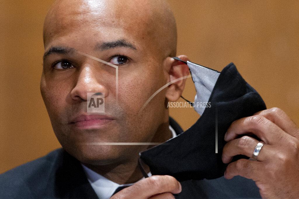 Michael Reynolds Surgeon General Jerome Adams takes off his face mask as he appears before a Senate Health, Education, Labor and Pensions Committee hearing to discuss vaccines and protecting public health during the coronavirus pandemic on Capitol Hill, Wednesday, Sept. 9, 2020, in Washington. (Michael Reynolds/Pool via AP)