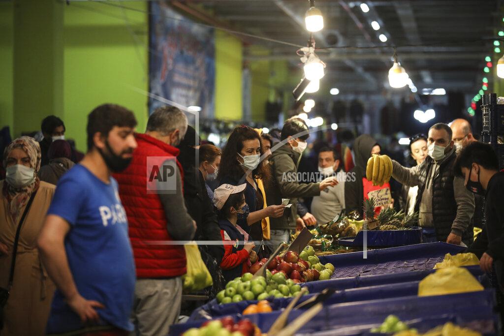 Emrah Gurel People shop at the local market in Istanbul, Thursday, April 29, 2021, a few hours before the start of the latest lockdown to help protect from the spread of the coronavirus. People stocked up on groceries, shoppers filled markets and many left cities for their hometowns or the southern coast as Turkey's strictest COVID-19 lockdown yet came into effect late Thursday. President Recep Tayyip Erdogan imposed a "full lockdown" until May 17 amid soaring COVID-19 infections and deaths. Turkey now ranks among the world's worst-hit countries and it's the first time that it is imposing a nearly three-week lockdown for the whole of the country. (AP Photo/Emrah Gurel)