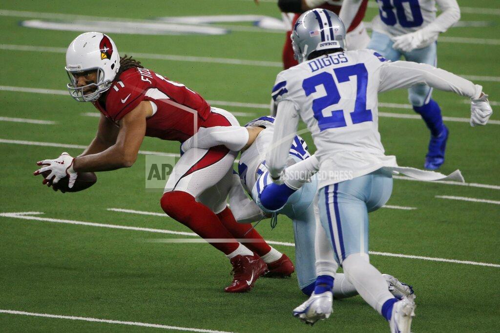 Michael Ainsworth Arizona Cardinals wide receiver Larry Fitzgerald fights for a first down after catching a pass as Dallas Cowboys cornerback Trevon Diggs (27) helps make the stop in the first half of an NFL football game in Arlington, Texas, Monday, Oct. 19, 2020. (AP Photo/Michael Ainsworth)