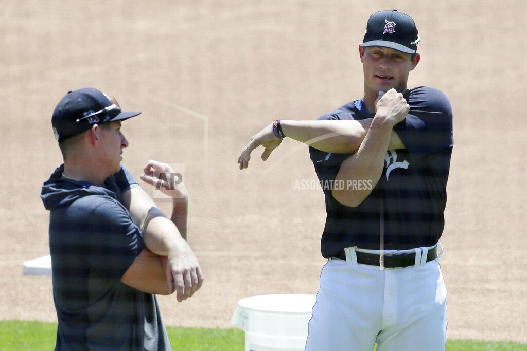 Duane Burleson Detroit Tigers' Spencer Torkelson, right, stretches with fellow infielder Frank Schwindel during baseball training camp at Comerica Park, Saturday, July 4, 2020, in Detroit. (AP Photo/Duane Burleson)