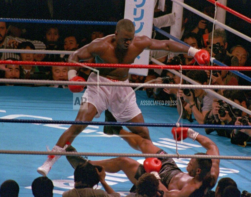 Tsugufumi Matsumoto FILE - In this Feb. 11, 1990 file photo, James "Buster" Douglas, stands over Mike Tyson who fell on his back after taking a series of blows in the 10th round of their world heavyweight title fight, in Tokyo. Douglas is marking the 30th anniversary of his upset boxing victory over Tyson with a campaign aimed to inspiring others who face long odds. The 59-year-old plans to announce the “42 to 1” initiative at the Ohio Statehouse Wednesday, Oct. 30, 2019, alongside city and state leaders and two-time Heisman Trophy winner Archie Griffin. The effort will include workforce development, diversity and self-help components. (AP Photo/Tsugufumi Matsumoto, File)