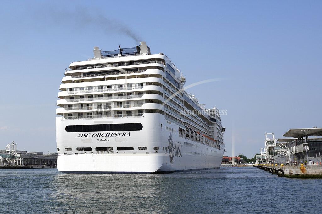 Antonio Calanni The the 92,409-ton, 16-deck MSC Orchestra cruise ship exits the lagoon as it leaves Venice, Italy, Saturday, June 5, 2021. The first cruise ship leaving Venice since the pandemic is set to depart Saturday amid protests by activists demanding that the enormous ships be permanently rerouted out the fragile lagoon, especially Giudecca Canal through the city's historic center, due to environmental and safety risks. (AP Photo/Antonio Calanni)