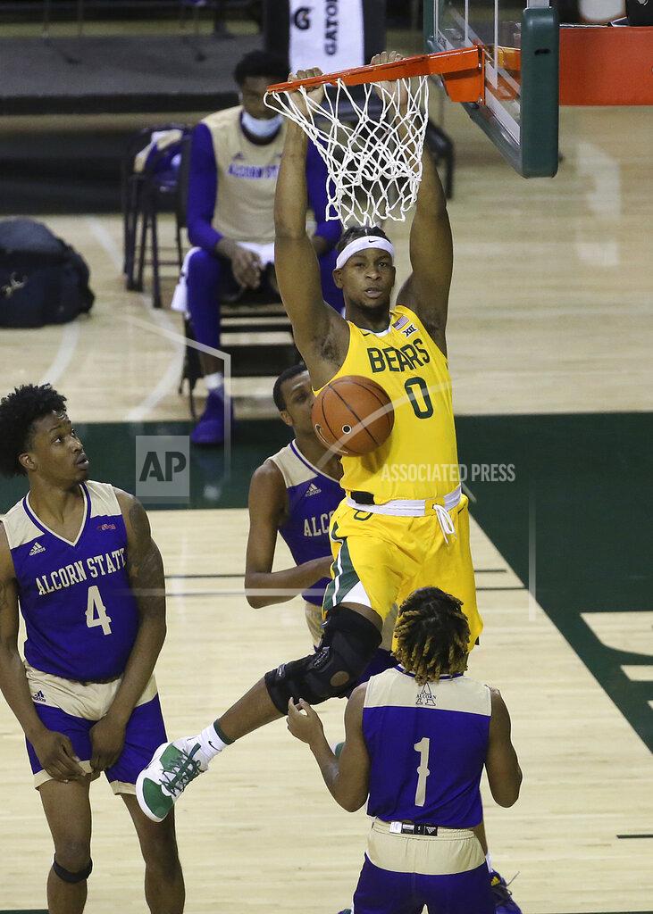 Jerry Larson Baylor forward Flo Thamba (0) scores against Alcorn State forward Anthony Fairley (4) and Alcorn State guard Kurk Lee (1) in the first half of an NCAA college basketball game, Wednesday, Dec. 30, 2020, in Waco, Texas. (AP Photo/ Jerry Larson)