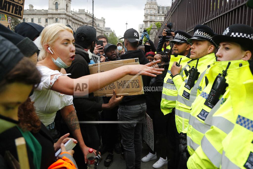 A protester yells at police during the Black Lives Matter protest rally in London, Sunday, June 7, 2020, in response to the recent killing of George Floyd by police officers in Minneapolis, USA, that has led to protests in many countries and across the US. (AP Photo/Frank Augstein)